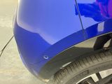 a close up of a car ' s tire with a sticker on it