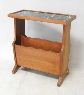 a small wooden magazine rack with a marble top