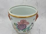 a white vase with a floral design on it
