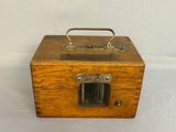 a small wooden box with a handle on top of it