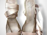 bride ' s shoes with a bow on the side of them