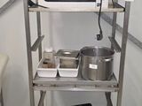 a microwave on a shelf in the corner of a room
