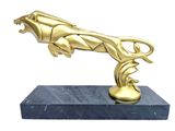 statue of a gold panther on a marble base