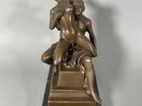 bronze statue of a man and a woman sitting on a marble base