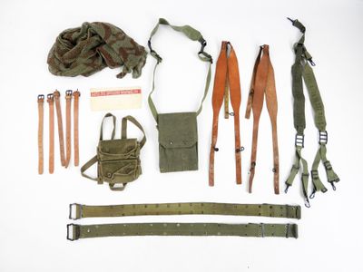 an image of a collection of military items laid out on a white surface