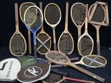 several tennis rackets are lined up against a black backdrop