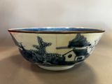 a blue and white bowl sitting on a table