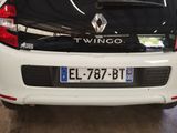 the back end of a white car with the trunk open