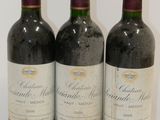 three bottles of wine sitting on top of a white table