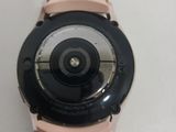 a close up of a watch on a white surface