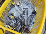 a basket full of screws and bolts on the floor