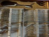 a lot of spoons and forks in a box