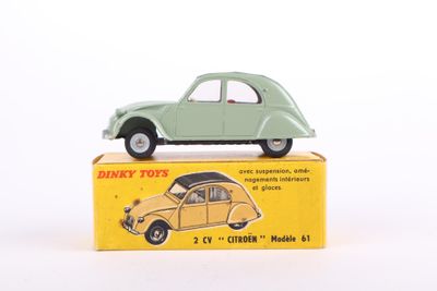 a green toy car sitting on top of a yellow box