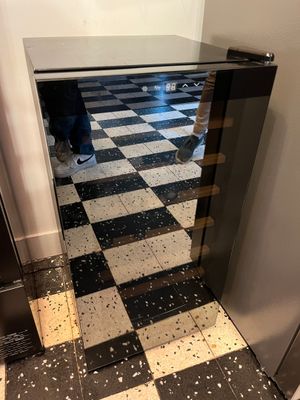 a person standing in front of a black and white checkered floor