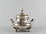 a silverplated teapot on stand with a lid