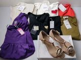 several pairs of women ' s shoes and a purse on a table