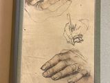an open book with a drawing of a person ' s hand and a drawing of a person ' s hand