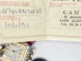 a close up of a business card with a watch on it