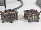 pair of antique silver plated candlestick holders on a white table