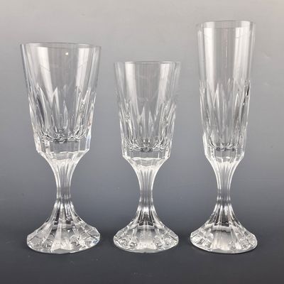 three clear wine glasses sitting next to each other on a table