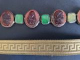 two bracelets with different colored stones on a black surface
