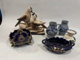 trois pièces de poterie différentes exposées sur une table