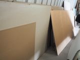 several pieces of plywood are stacked up in a garage