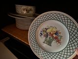 a person holding a plate with a bunch of flowers on it