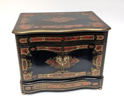 an image of a black and gold chest with a floral decoration