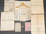 an assortment of old papers and other items on display on a table