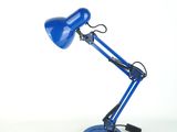 a blue desk lamp sitting on top of a table next to a white wall