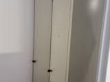 a white closet in the corner of a room