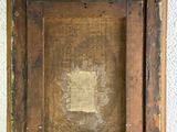 an old picture frame with a piece of paper in it