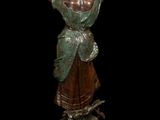 a bronze statue of a woman holding a bird in her hand