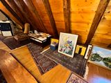 a picture of a living room with a couch and a painting on the wall