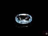 a close up of a blue diamond on a black surface