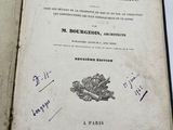 an old book with writing on it sitting on top of a table