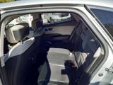 the back seat of a car with the driver ' s seat folded down