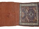 a close up of a brown and blue rug on a white surface