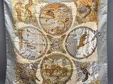 a close up of a piece of cloth with animals and birds on it