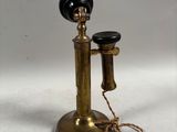an antique brass telephone on a white background with a cord