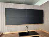 a kitchen with a sink and a black counter top