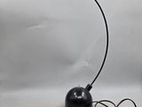 an image of a black lamp with a cord attached to it