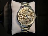 a watch that is sitting on top of a pillow