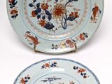 two plates with different designs on them on a table