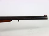 a rifle with a wooden barrel on a white background