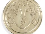 a silver coin with a woman ' s face on it