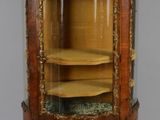 une vitrine ancienne dotée d'une porte vitrée et de garnitures dorées