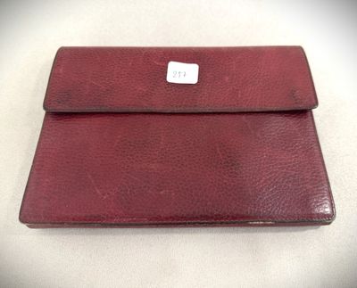 an image of a red leather wallet with a white tag on it