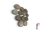 a lot of coins that are on a white surface